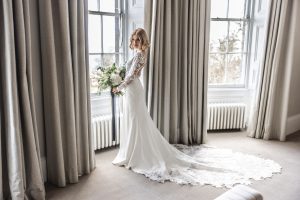 Bride standing by the window in the Bridal suite