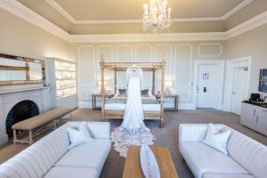 Bride's dress hung on the four poster bed in the Bridal suite