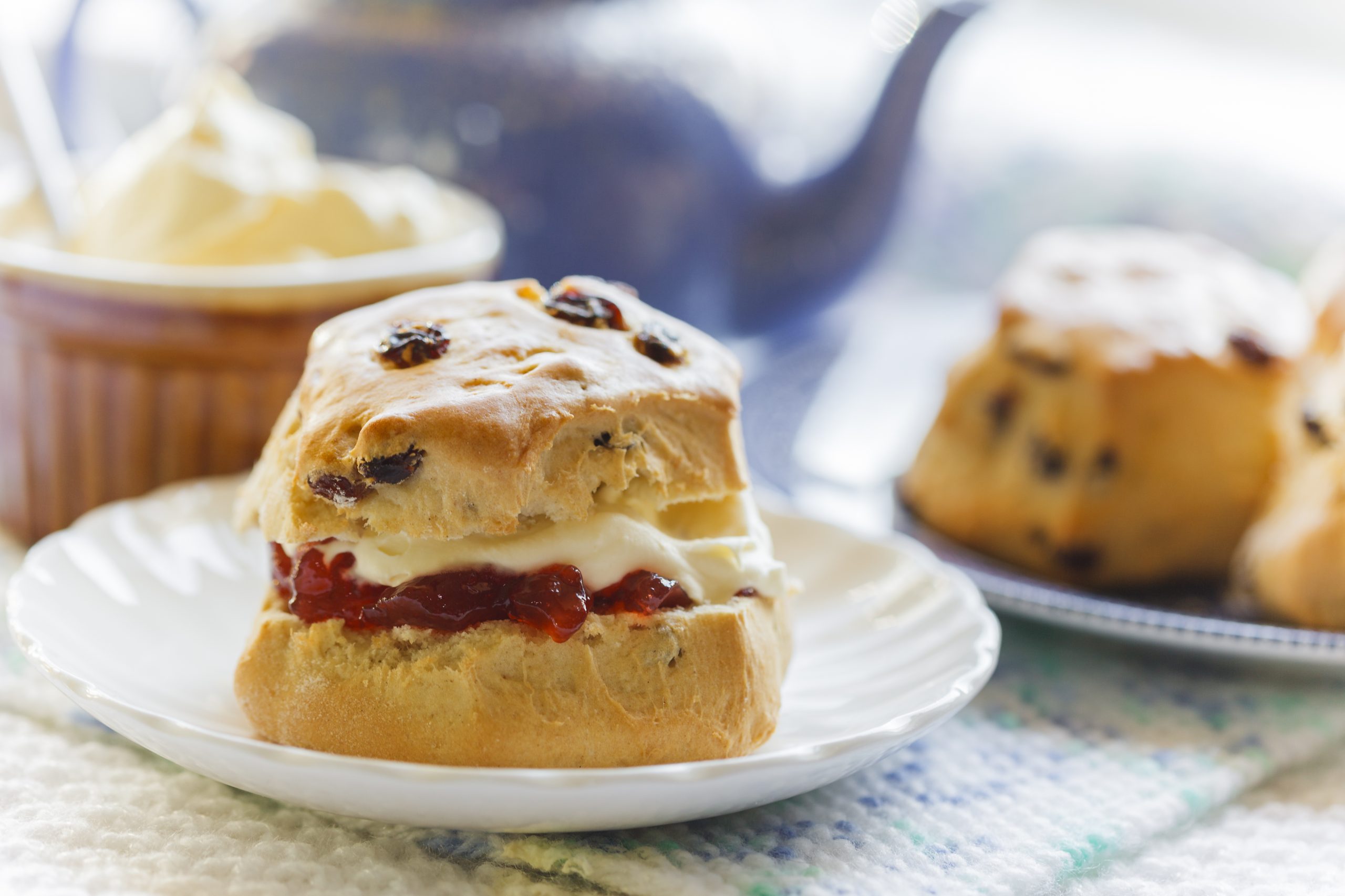 Traditional,Afternoon,Tea,With,Scones,,Jam,And,Cream,,Blue,Teapot