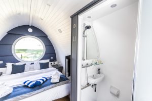 Shower and bed in pod accommodation